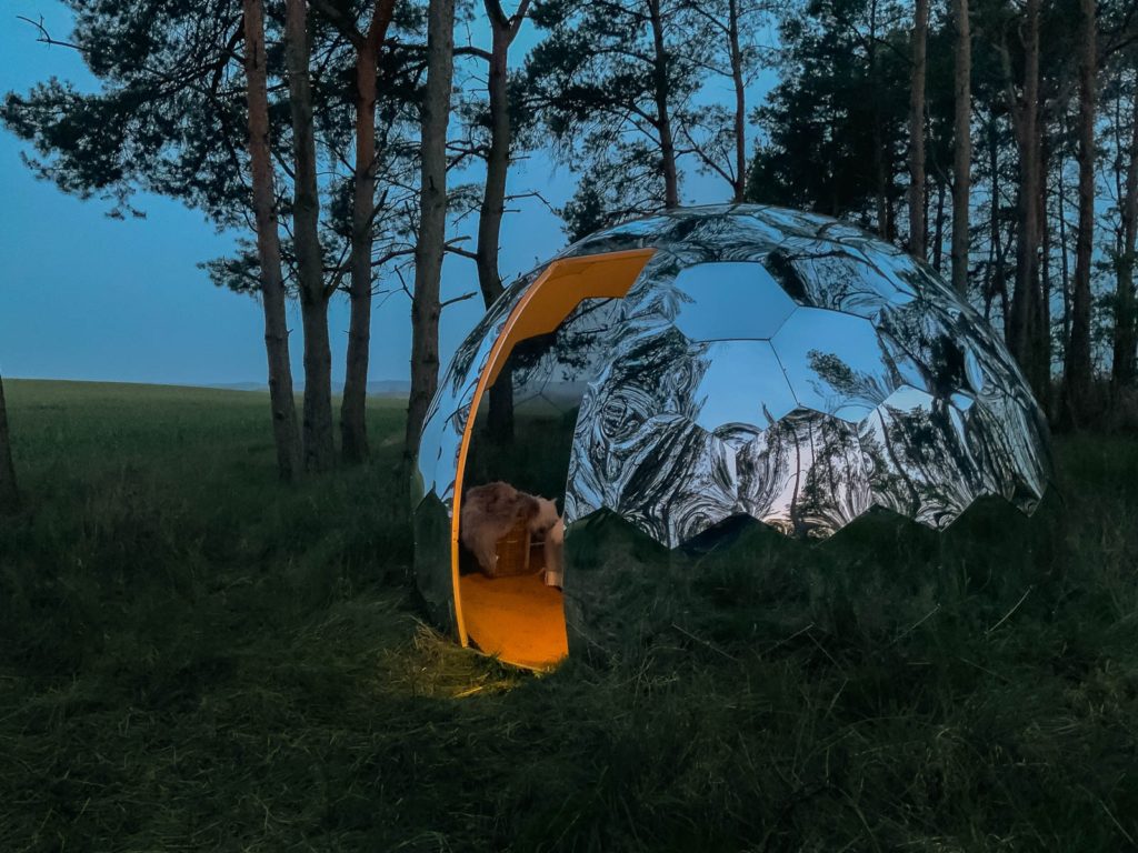 a mirrored dome glamping pod in the woods - 5 camping experiences to try