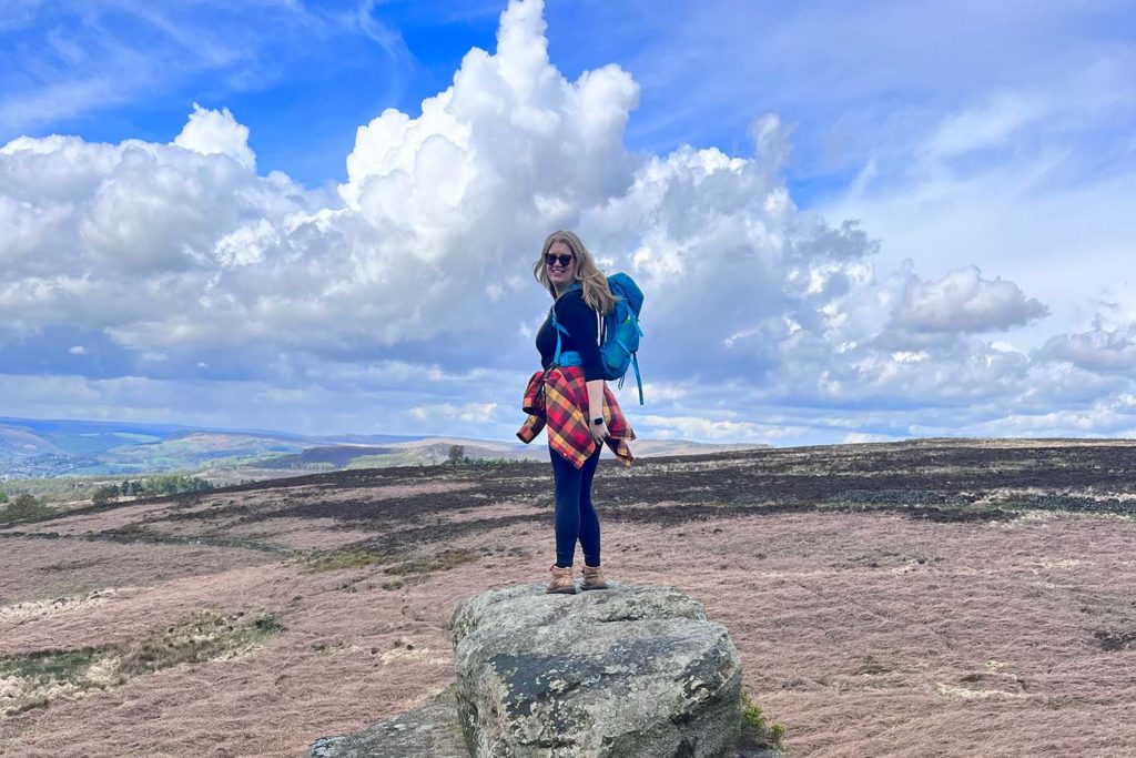 Jen lowthrop on a rock on Baslow Edge in the Peak District